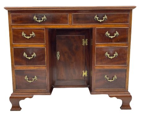 George III style mahogany kneehole desk, moulded rectangular top over eight cockbeaded drawers and central recessed cupboard,