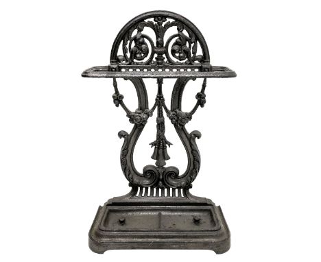 Victorian style cast iron umbrella and stick hall-stand, arched and scroll cast pediment over lyre shaped back, decorated wit