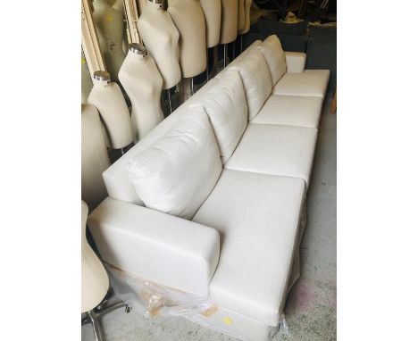 A Large four seater cream fabric sofa (W353cm D100cm H83cm)