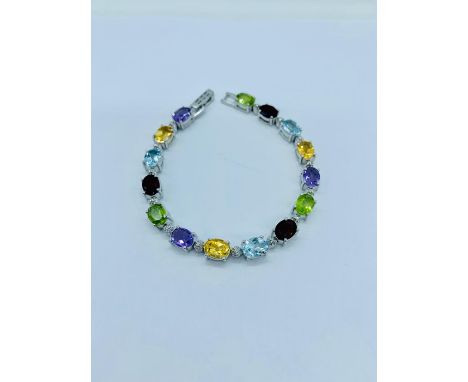 A Silver line bracelet set with amethyst, citrine, garnet, peridot and aquamarine 