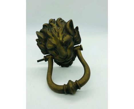 A Brass lion head door knocker