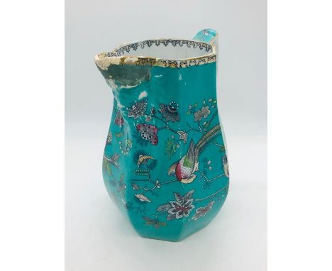 A Jade green Davenport jug with exotic birds and spout with face details AF
