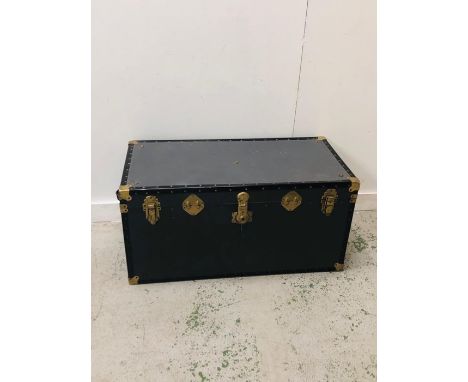 A Large blue travel trunk with decorative brass trimmings and leather handles (H50cm D50cm W103cm)