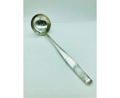 A silver ladle marked 833.