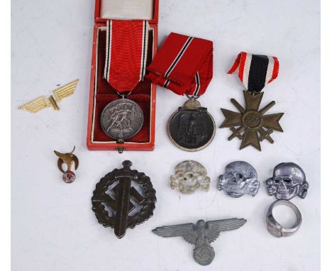 A German War Merit Cross with swords, together with an SA Sports badge, an SS totenkopf x3, an eagle head ring and RAFA lapel