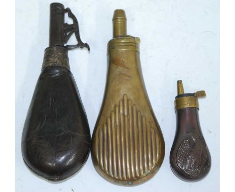 An early 20th century brass powder flask, of fluted pear shape, the nozzle stamped Sykes, 19cm, together with a small copper 