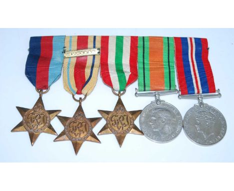 A group of five WW II medals, to include Italy Star, Africa Star with 8th Army clasp, 1939-1945 Star, Defence and War, togeth