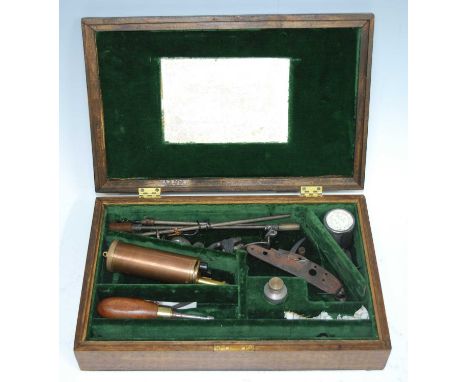 A Victorian oak pistol case, having a green felt lined interior containing various eccoutrements to include a copper powder f