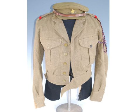 A WW II Battle Dress Blouse with Labour Corps collar badges, together with a similar pair of trousers, peaked cap, leather bo