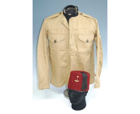 A Royal West African Frontier Force fez, of typical form with black tassle and R.W.A.F.F. badge, the silk and woven interior 