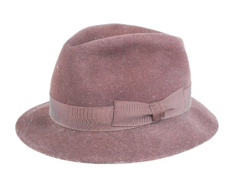 A 20th century brown wool hat with canvas trim, similar to those used by the Land Army, containined in an associated tin hat 