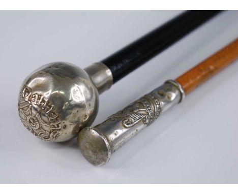 An early 20th century swagger stick, having an ebonised shaft and nickel cap with Rifle Brigade crest, 68cm, together with on