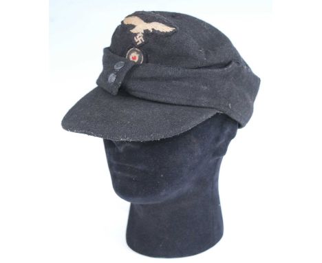 A German M43 Field cap, in black with Luftwaffe badge, stamped to the interior Weber & Ott and dated 1944, together with one 