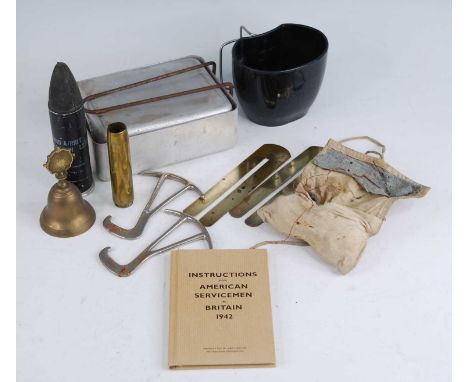 A small collection of miscellaneous items to include an inert L2A2 1.5 inch Baton round, a pair of steel boot pulls, each sta