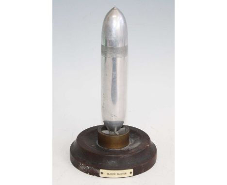 A mid-20th century chrome table lighter, in the form of a WW II RAF "Blockbuster" bomb, mounted on a wooden plinth with title