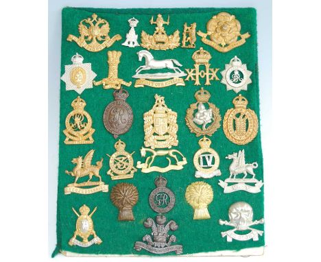 A collection of British Army cap badges and insignia, to include The Cambridgeshire Regiment, The Norfolk Regiment, The Suffo