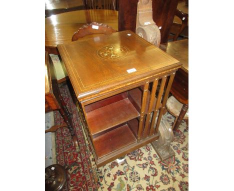19th Century mahogany and inlaid revolving bookcase on crossover stand with brass and ceramic casters, 19.5ins square, 34ins 