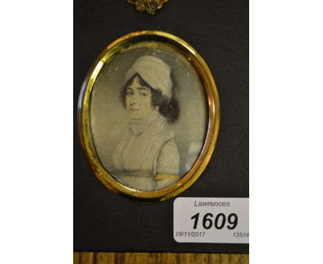 19th Century watercolour portrait miniature of a lady wearing a white headdress in an ebonised frame