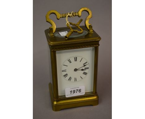 Late 19th or early 20th Century brass cased carriage clock, the enamel dial with Roman numerals, the two train movement strik