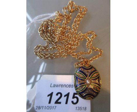 Victorian oval enamel decorated gold pendant set diamonds and single pearl suspended from a gilt metal chain