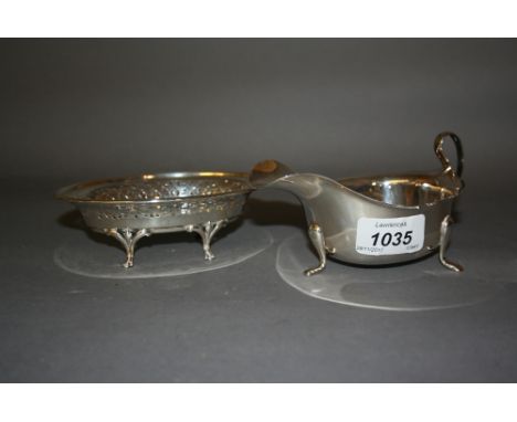 London silver helmet shaped cream jug on low supports, together with an oval pierced Birmingham silver trinket dish