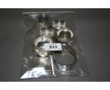 Five various silver napkin rings, a silver bangle and a compact