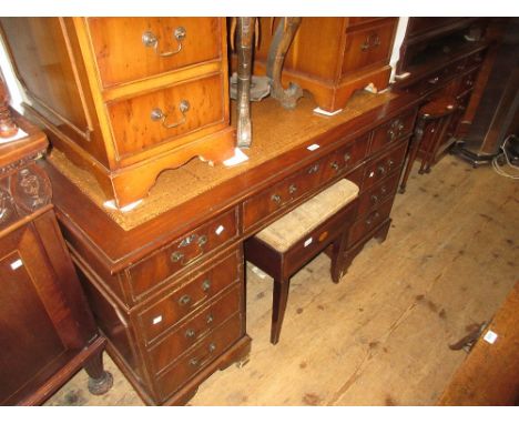Reproduction mahogany pedestal desk having brown leather and gilt tooled inset top above an arrangement of nine drawers with 