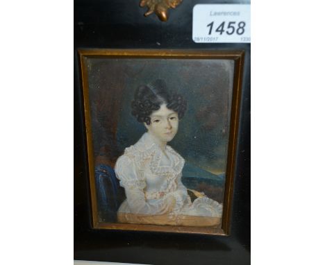 19th Century ebonised framed miniature portrait of a young lady seated in a landscape.