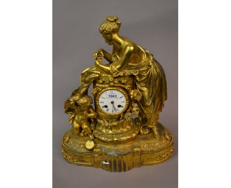 19th Century French gilt metal figural mantel clock, the enamel dial with Roman numerals, the two train movement striking on 