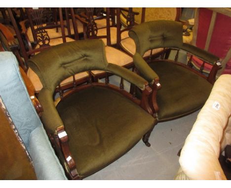 Pair of late 19th / early 20th Century mahogany tub shaped chairs having green upholstery, with spindle backs raised on turne