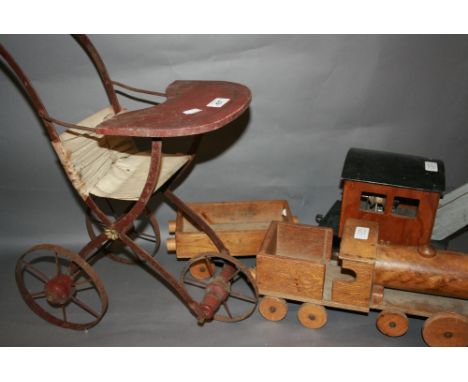 Early doll's metal and wooden pushchair together with a wooden model train and crane