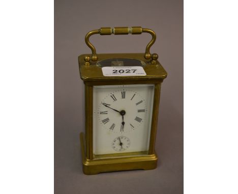 Small brass cased carriage clock, the enamel dial with Roman numerals and subsidiary alarm dial