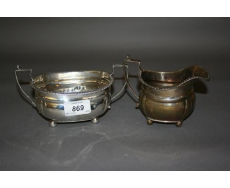 London silver cream jug and sugar basin on ball supports