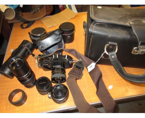 Chinon 35mm SLR camera with extra zoom lens and various accessories in fitted case