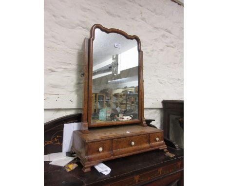 Figured walnut swing frame box toilet mirror with three drawers, raised on ogee bracket feet in Georgian style