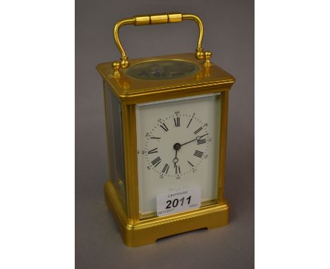 Early 20th Century French brass cased carriage clock, the enamel dial with Arabic and Roman numerals and single train movemen