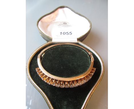 Yellow gold bangle with black enamel decoration set nineteen graduated brilliant cut claw set diamonds