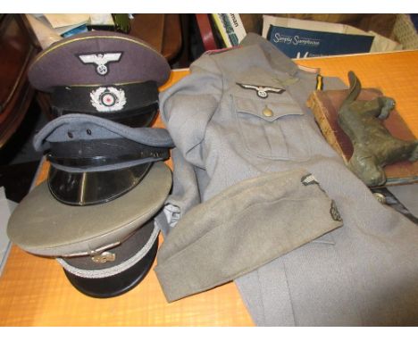 Bag containing a small quantity of German theatrical clothing, 19th Century leather book and a cast iron nutcracker in the fo
