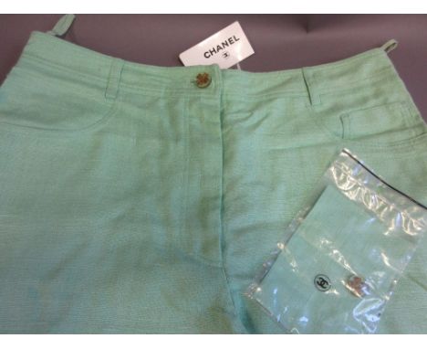 Pair of ladies green Chanel trousers (with label, bag containing material patch and spare button)