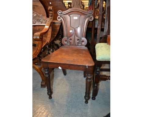 Victorian mahogany hall chair with a carved panel back, a walnut framed tapestry panel firescreen on cabriole supports togeth