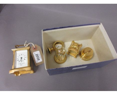 Small English gilt brass carriage clock, the enamel dial with Roman numerals, together with four miniature gilt metal novelty