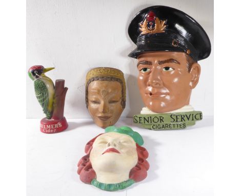 A painted plaster head advertising Senior Service cigarettes, together with a smaller Art Deco-style head, a carved and paint