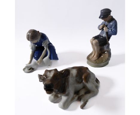 Royal Copenhagen porcelain figure group (mid 20th century, Danish factory), a seated young boy sharpening a stick with a knif