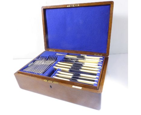 A fine early 20th century oak-cased silver plated flatware and cutlery service comprising six table forks, six dessert forks,