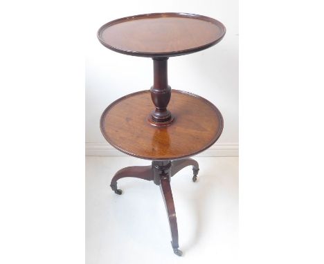 A George III period two-tier mahogany wine table on tripod base with brass castors (the top shelf 46cm diameter x 98cm high)