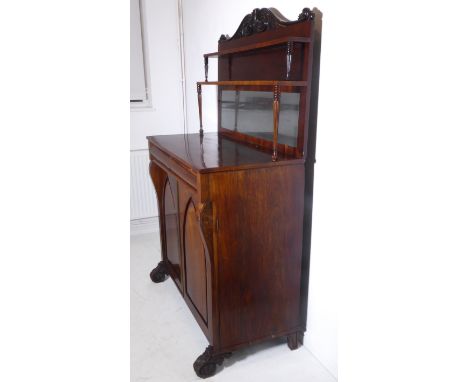 A late Regency period rosewood chiffonier; the carved crested galleried top with mirrored back above a single full-width cush