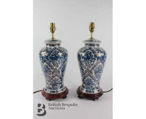 Pair of blue and white decorative lamp stands, complete with shades, approx 35 cms not including the fittings.&nbsp;