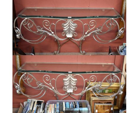 KEVIN MCLOUD; a pair of contemporary silvered metal hall or console tables, each with serpentine glass top above scrolling op