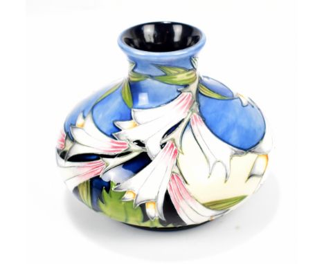 MOORCROFT; a floral tubeline decorated squat bottle vase on cream, light blue and navy grounds, impressed marks and year ciph