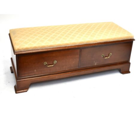 A mahogany ottoman with hinged seat above two base drawers, raised on bracket feet (converted from a wardrobe base).